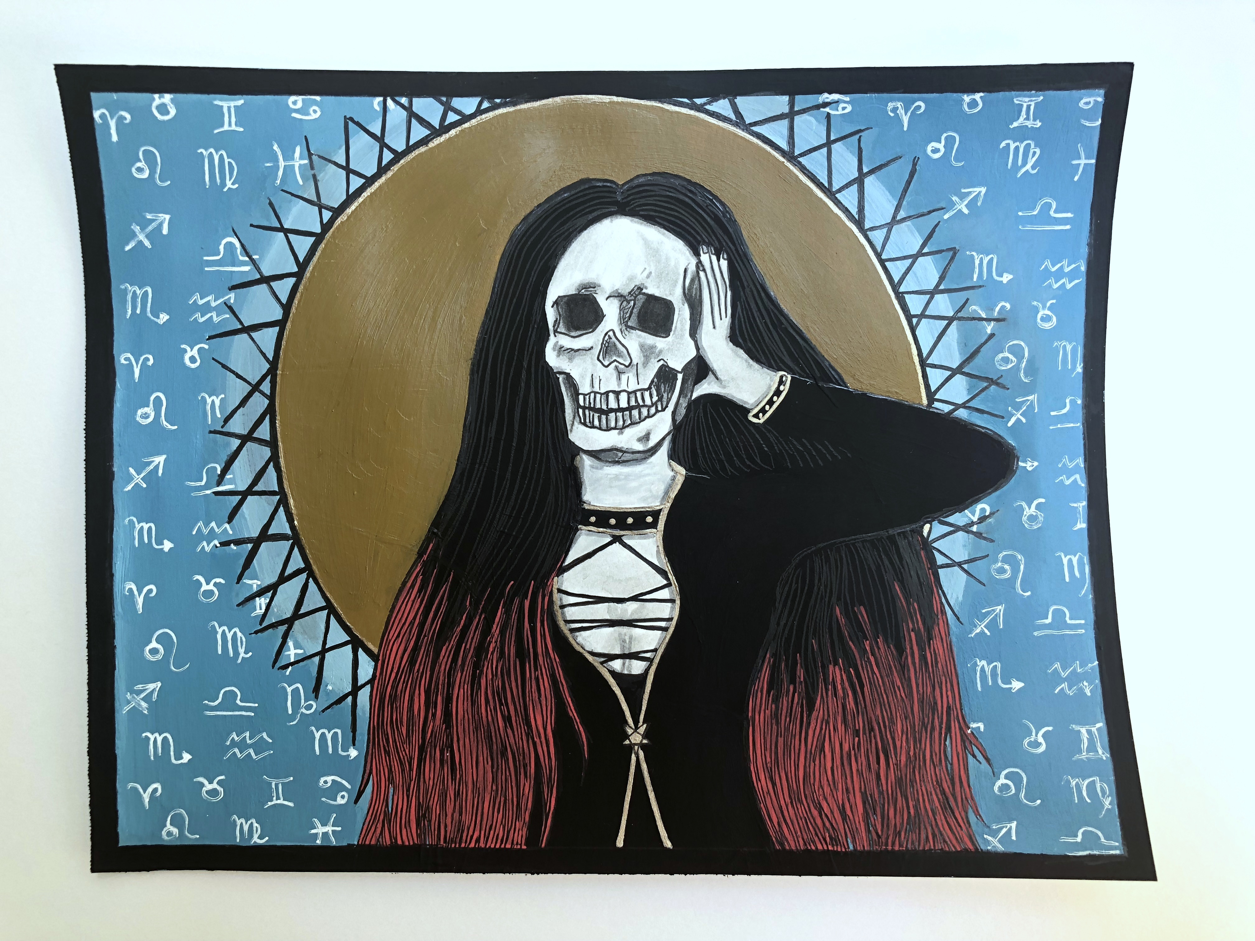 An experimental mixed media art piece (Laughing at My Disaster) of a goth woman holding a skull to her head in front of a background of zodiac signs, inspired by the song Upsidedown by Lacuna Coil; I created the piece with ink, acrylic paint, and acrylic marker.