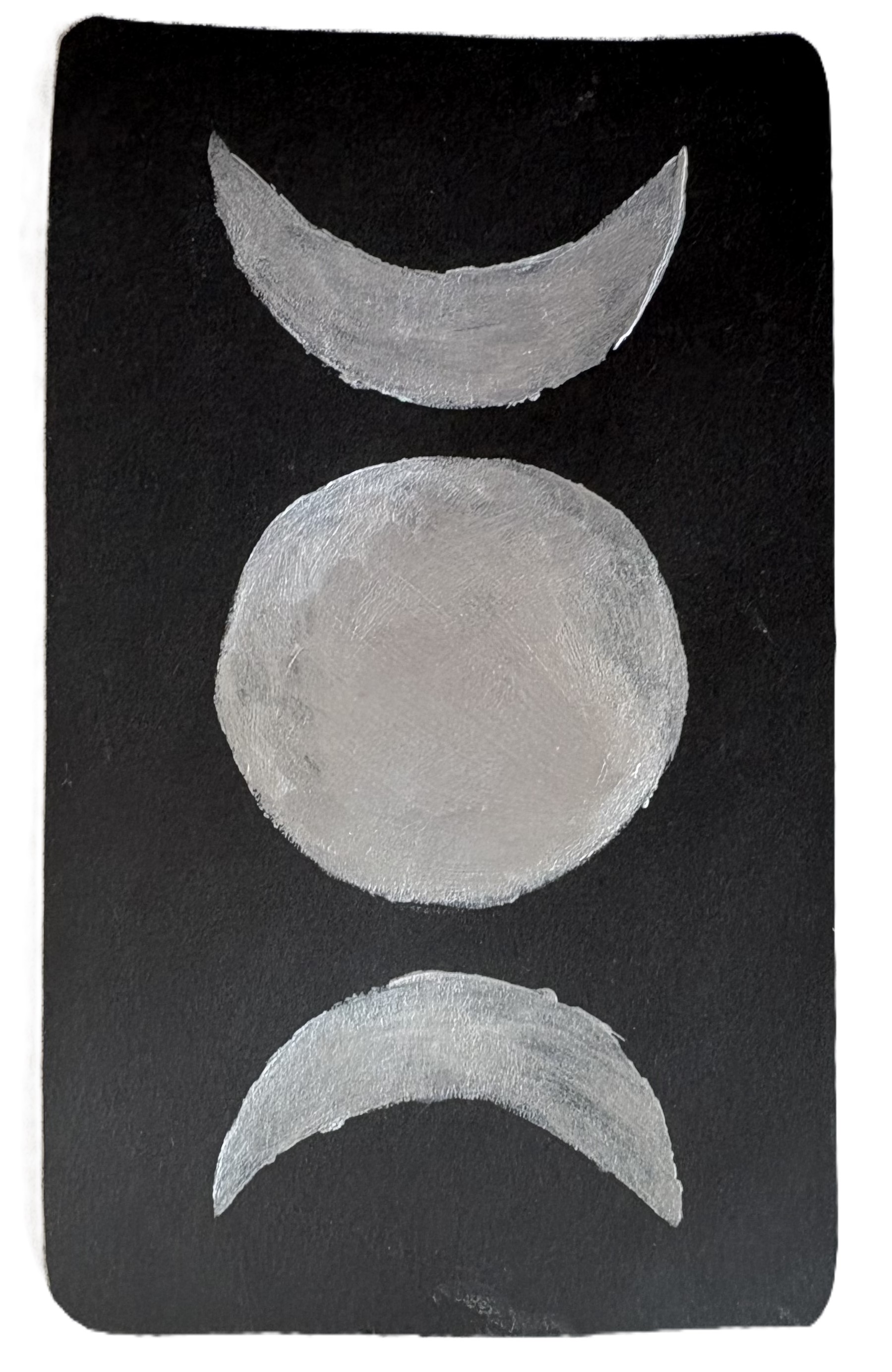Triple Moon symbol on the back of the tarot cards in silver.