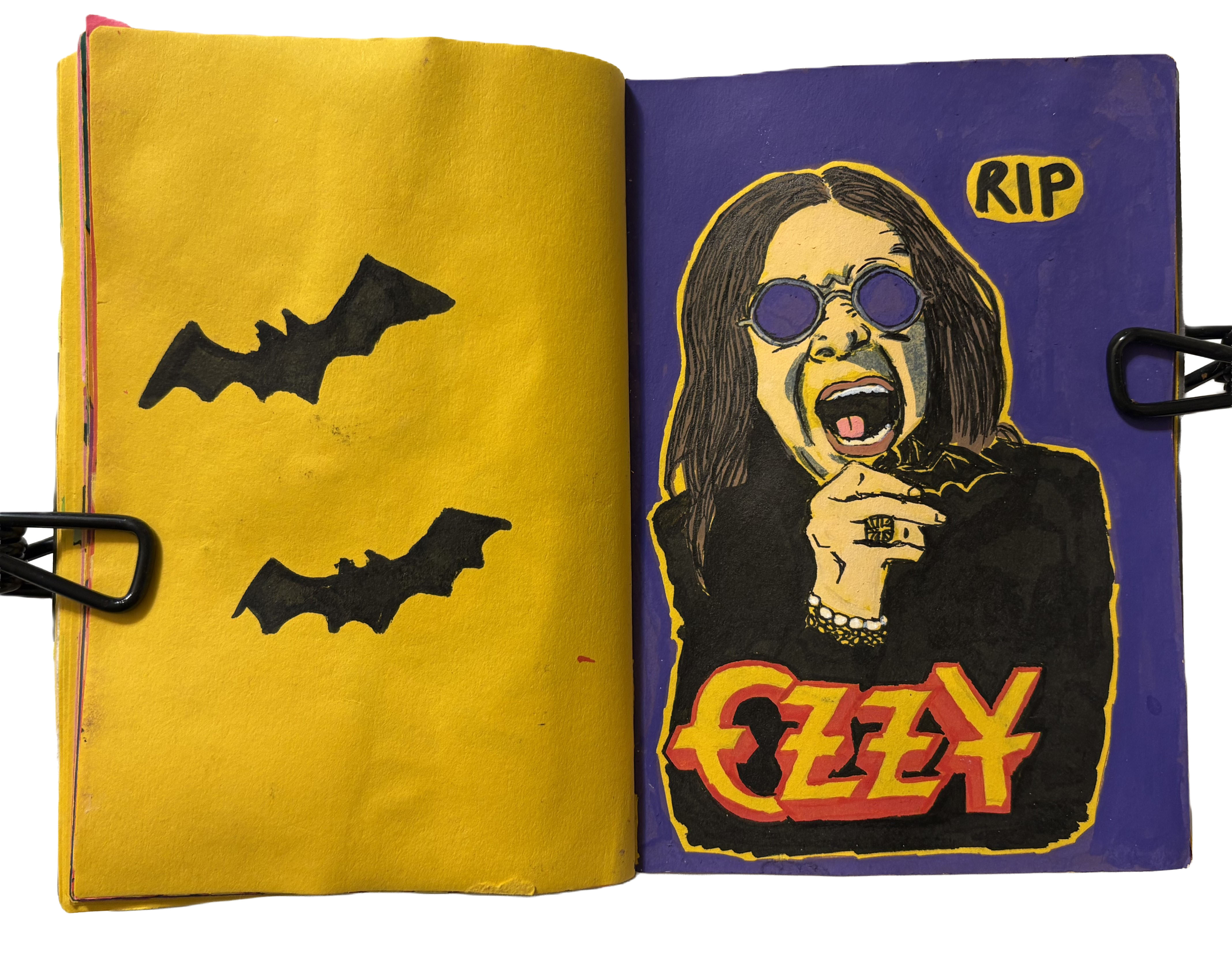 July 2025: A mixed media art journal page with stamps of black bats next to a tribute illustration of Ozzy Osbourne.
