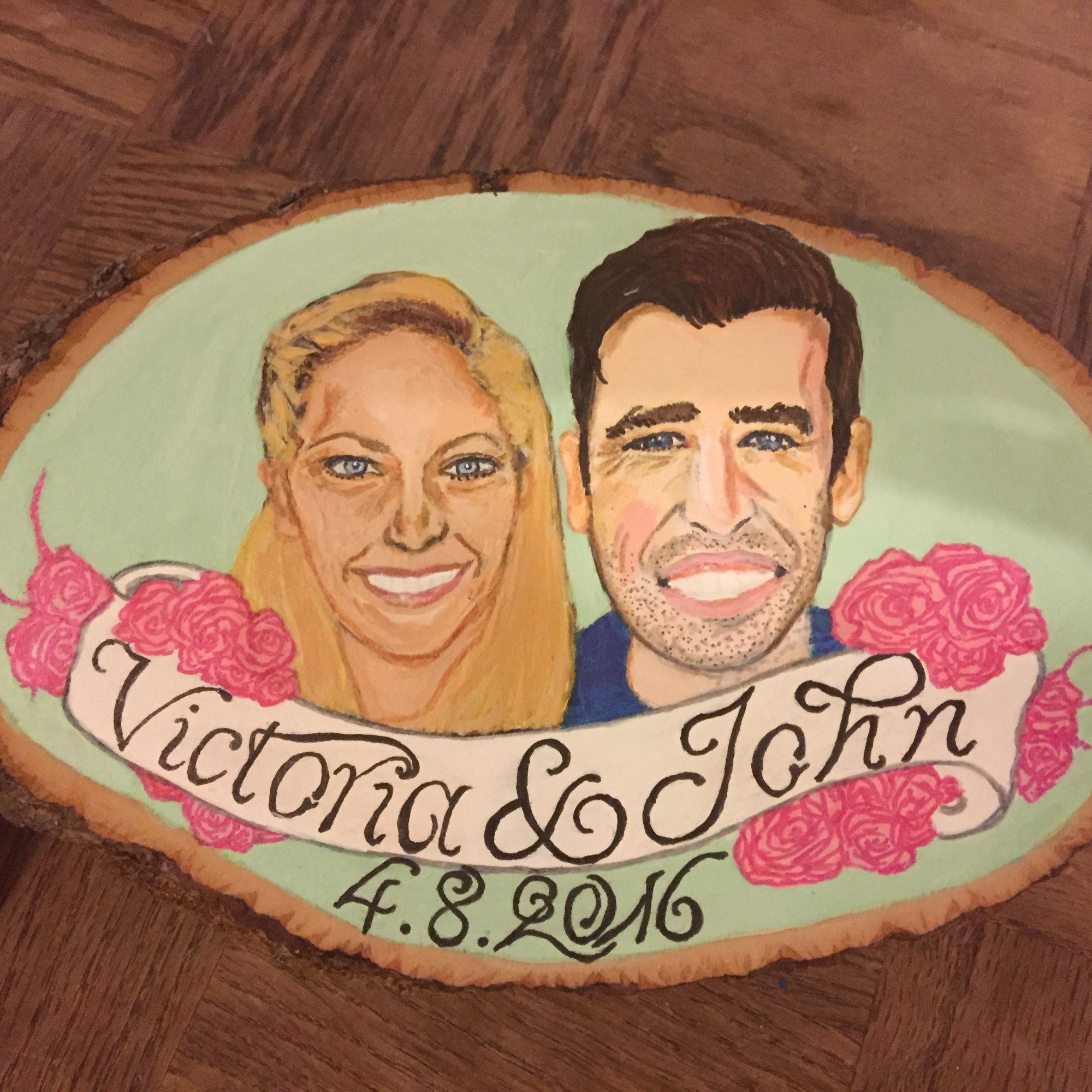 A painted portrait of a couple on a wood block as a wedding gift, created with ink and acrylic paint.