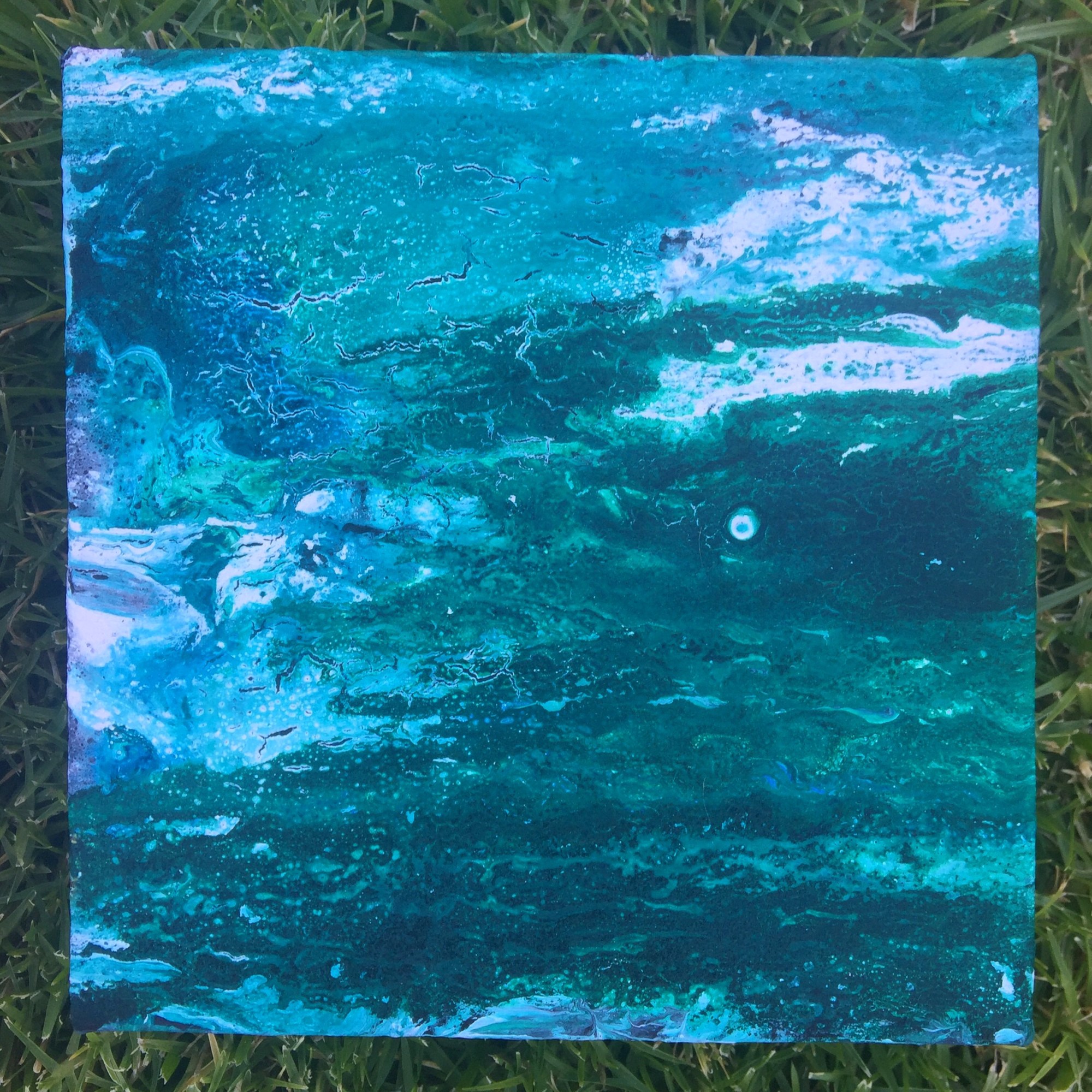 An acrylic pour that looks like the ocean on a square canvas gifted to my brother-in-law.