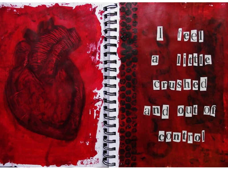 A mixed media art journal painting of an anatomical heart and cut outs of lyrics from Crushed by the band Collide; the page was created with ink, collage material, and acrylic paint.